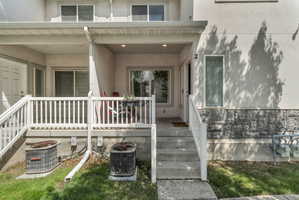 Doorway to property with stucco siding and a porch