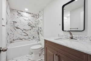 Full bath with vanity, light marble finish floors, shower / bath combination, and recessed lighting