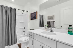 Full bath featuring vanity and shower / bath combo