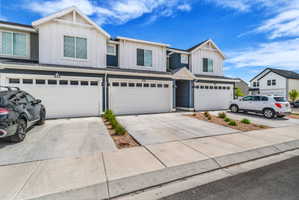View of front facade featuring board and batten siding, an attached garage, and concrete driveway