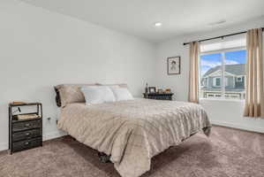 Bedroom featuring baseboards and carpet flooring