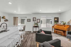 Living room with wood finished floors, plenty of natural light, and recessed lighting