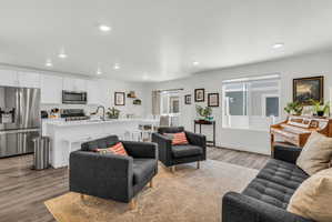 Living area featuring light wood-type flooring and recessed lighting