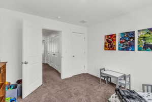 Bedroom with carpet flooring and baseboards