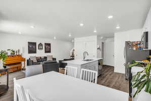 Dining area with dark wood-style flooring and recessed lighting