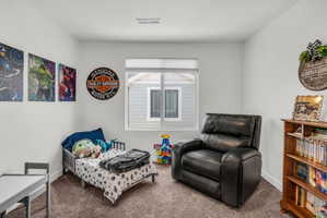 Carpeted bedroom featuring baseboards