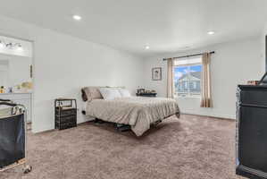 Bedroom with light carpet and recessed lighting