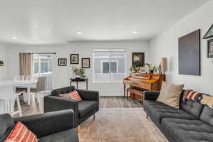 Living area featuring wood finished floors and recessed lighting