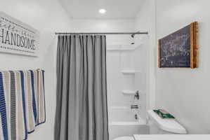 Bathroom with toilet and shower / bath combo