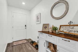 Entrance foyer featuring dark wood-type flooring and recessed lighting