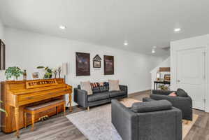 Living room featuring light wood finished floors and recessed lighting