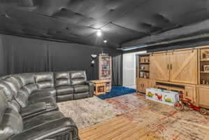 Basement with a barn door and carpet flooring