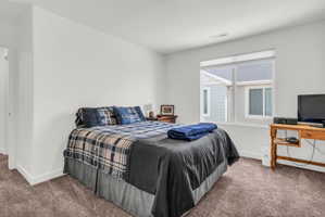 Carpeted bedroom with baseboards
