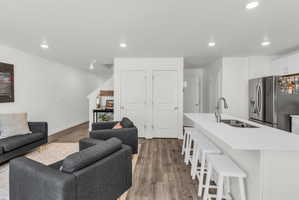 Living room featuring wood finished floors, recessed lighting, and a textured ceiling