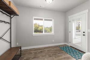 Entryway with wood finished floors and baseboards
