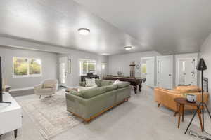 Carpeted living area featuring billiards and baseboards