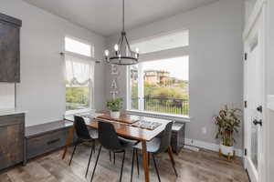 Dining space with a chandelier and light wood-style flooring