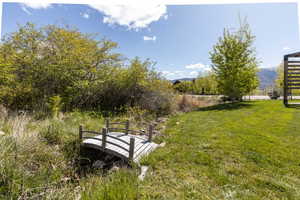 View of green lawn featuring a mountain view