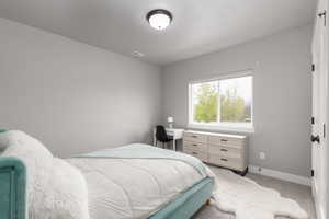 Carpeted bedroom featuring baseboards