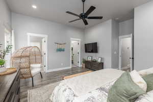 Bedroom with dark wood-type flooring, ceiling fan, and recessed lighting
