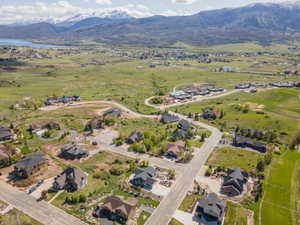 Aerial view of property's location featuring a mountainous background and nearby suburban area