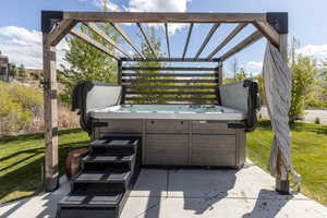 View of patio / terrace with a pergola and a hot tub