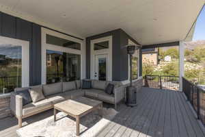 Wooden terrace featuring an outdoor lounge area