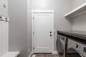 Laundry room featuring separate washer and dryer and dark wood-style floors