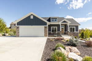 Craftsman-style home featuring a porch, a garage, driveway, and a shingled roof