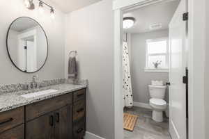 Bathroom featuring vanity and curtained shower