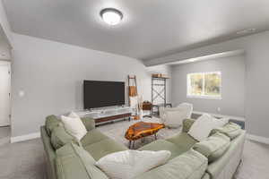 Living area with light carpet and baseboards