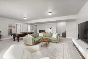 Living room with billiards table and light colored carpet