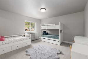 Bedroom featuring light colored carpet and baseboards