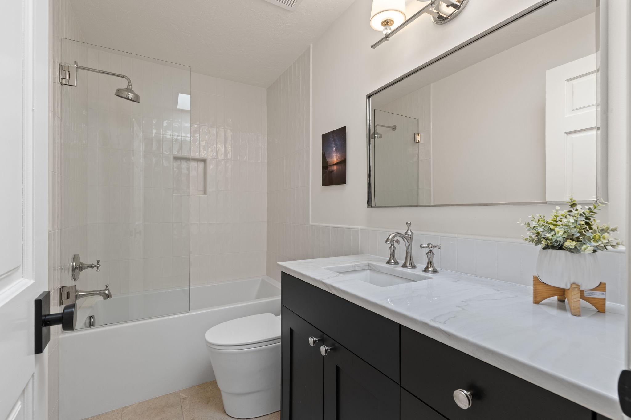 Bathroom with vanity, shower / tub combination, and light tile patterned floors