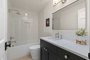 Bathroom with vanity, shower / tub combination, and light tile patterned floors
