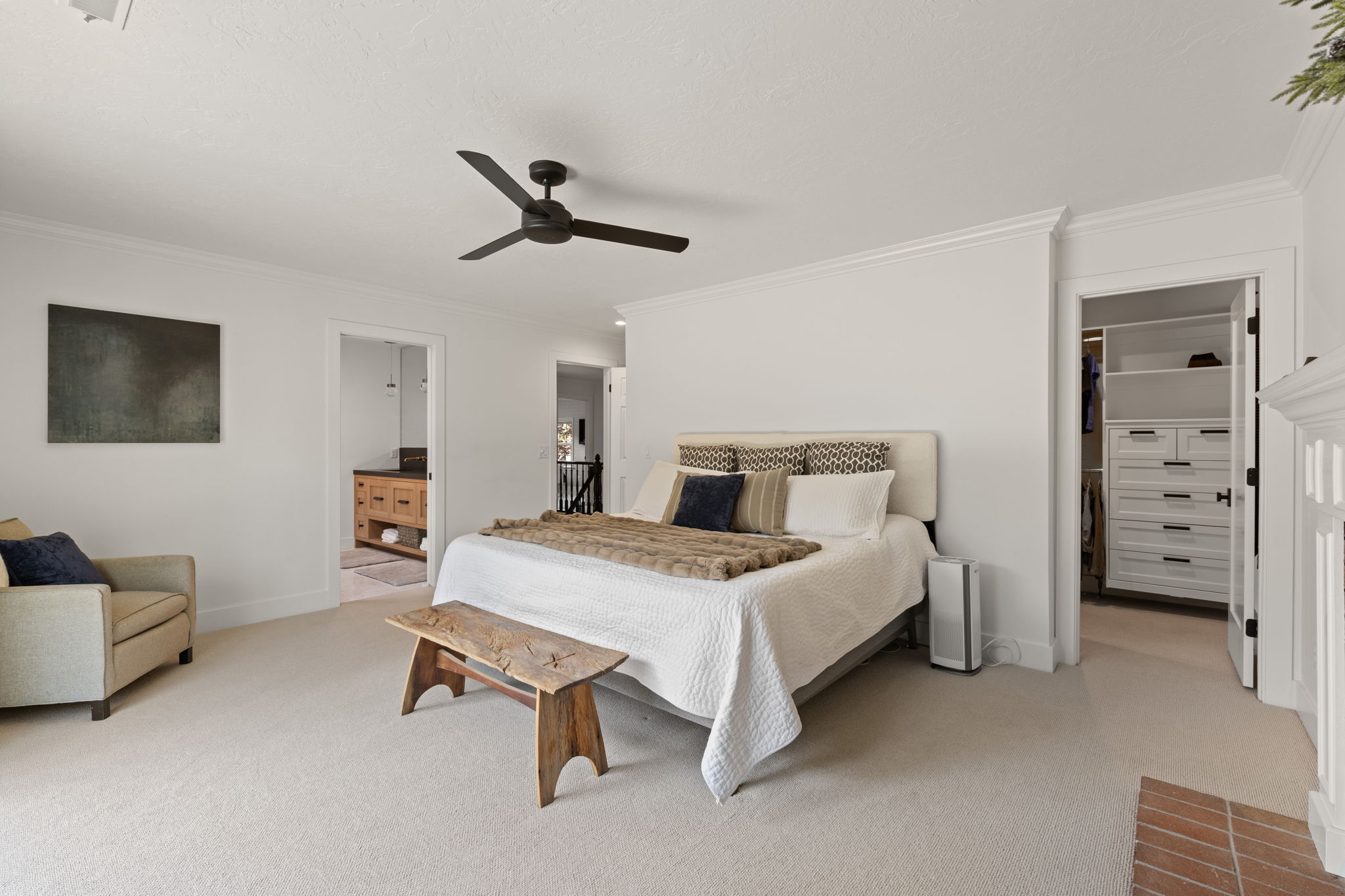 Bedroom featuring a spacious closet, ornamental molding, light carpet, and ceiling fan