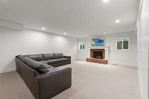 Living room with light carpet, a fireplace, and recessed lighting