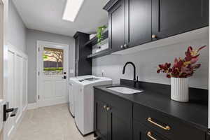 Laundry area with cabinet space and washing machine and clothes dryer