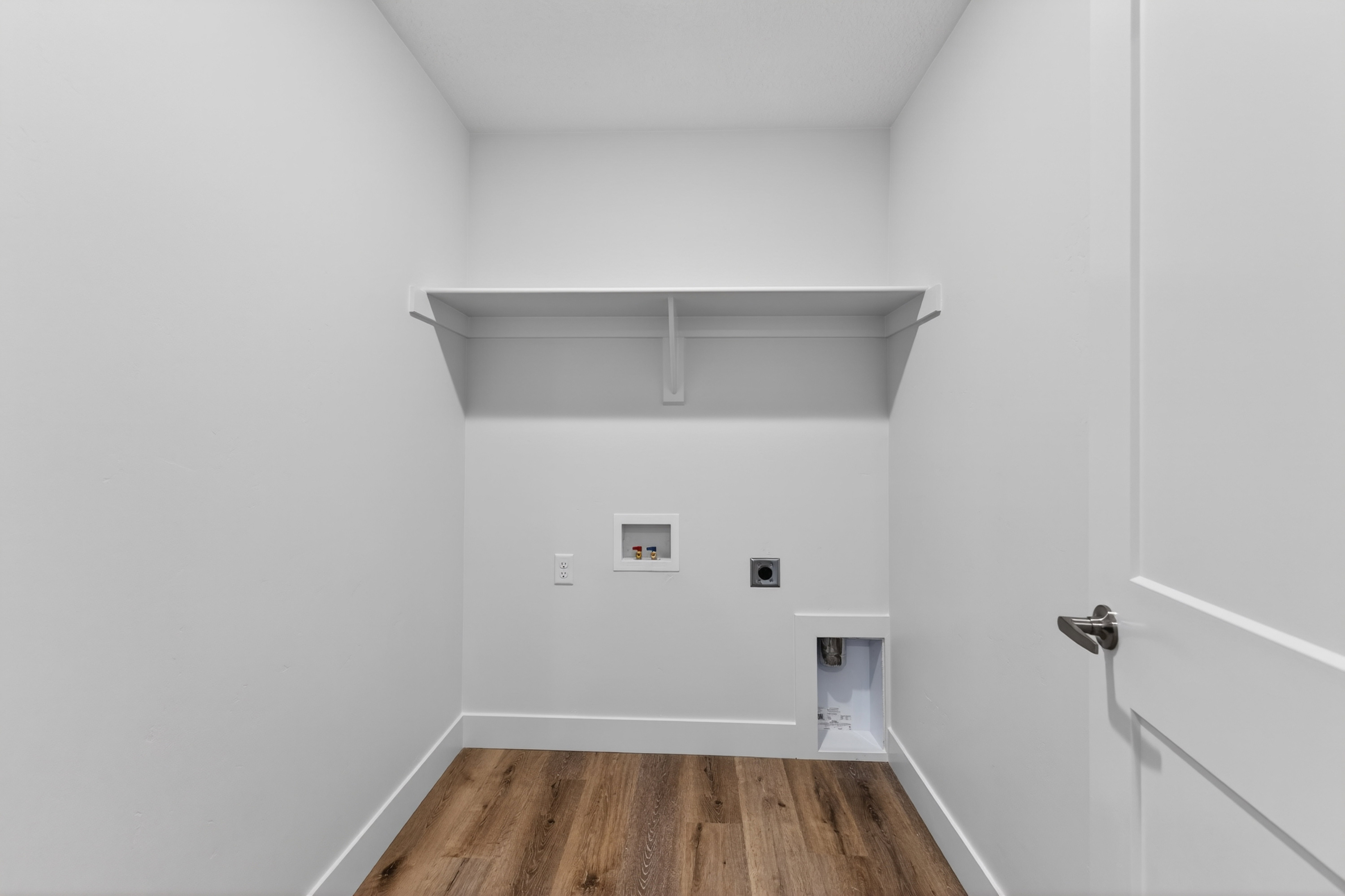 Laundry area featuring hookup for an electric dryer, wood finished floors, and hookup for a washing machine