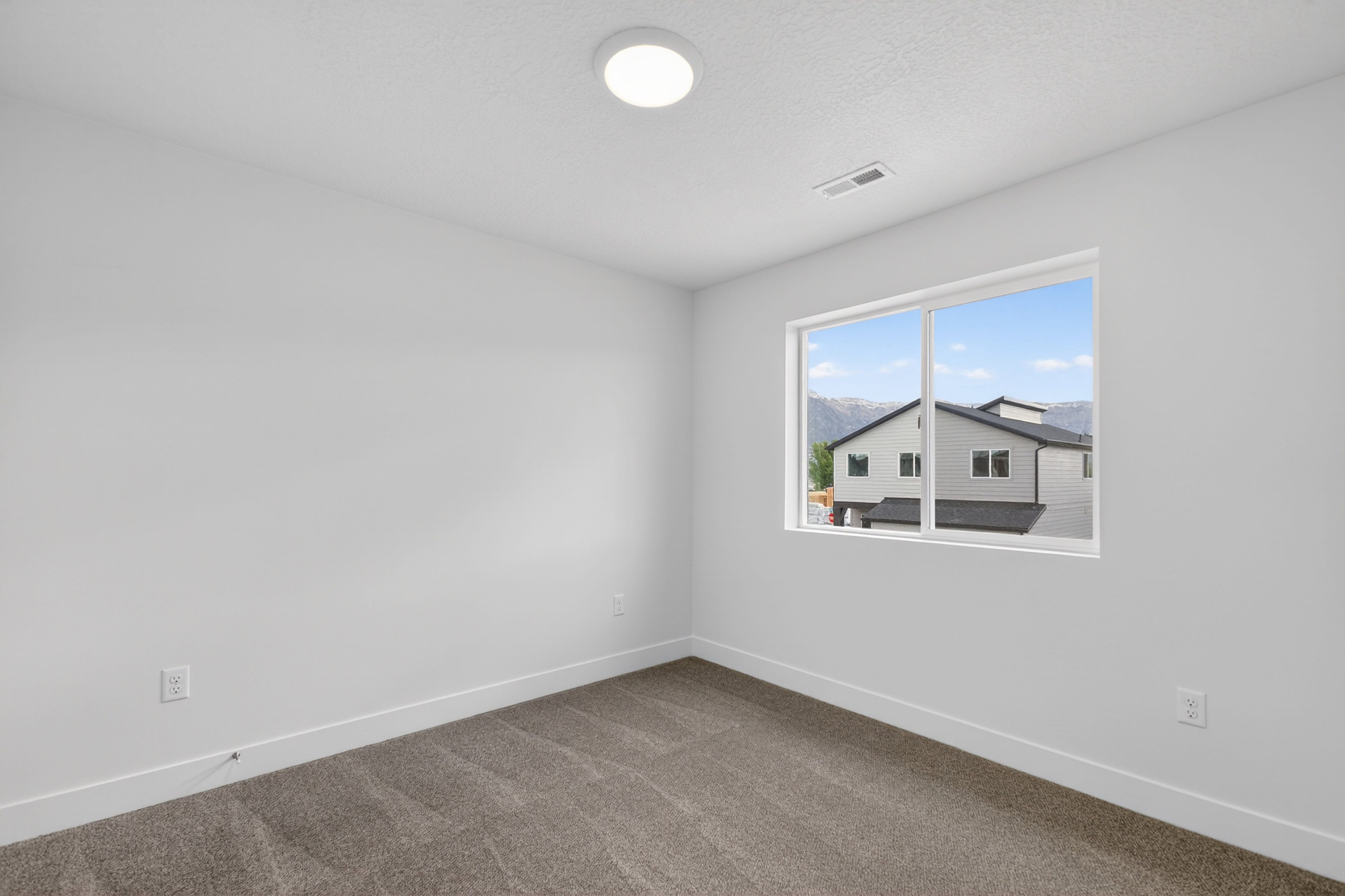 Carpeted empty room with baseboards