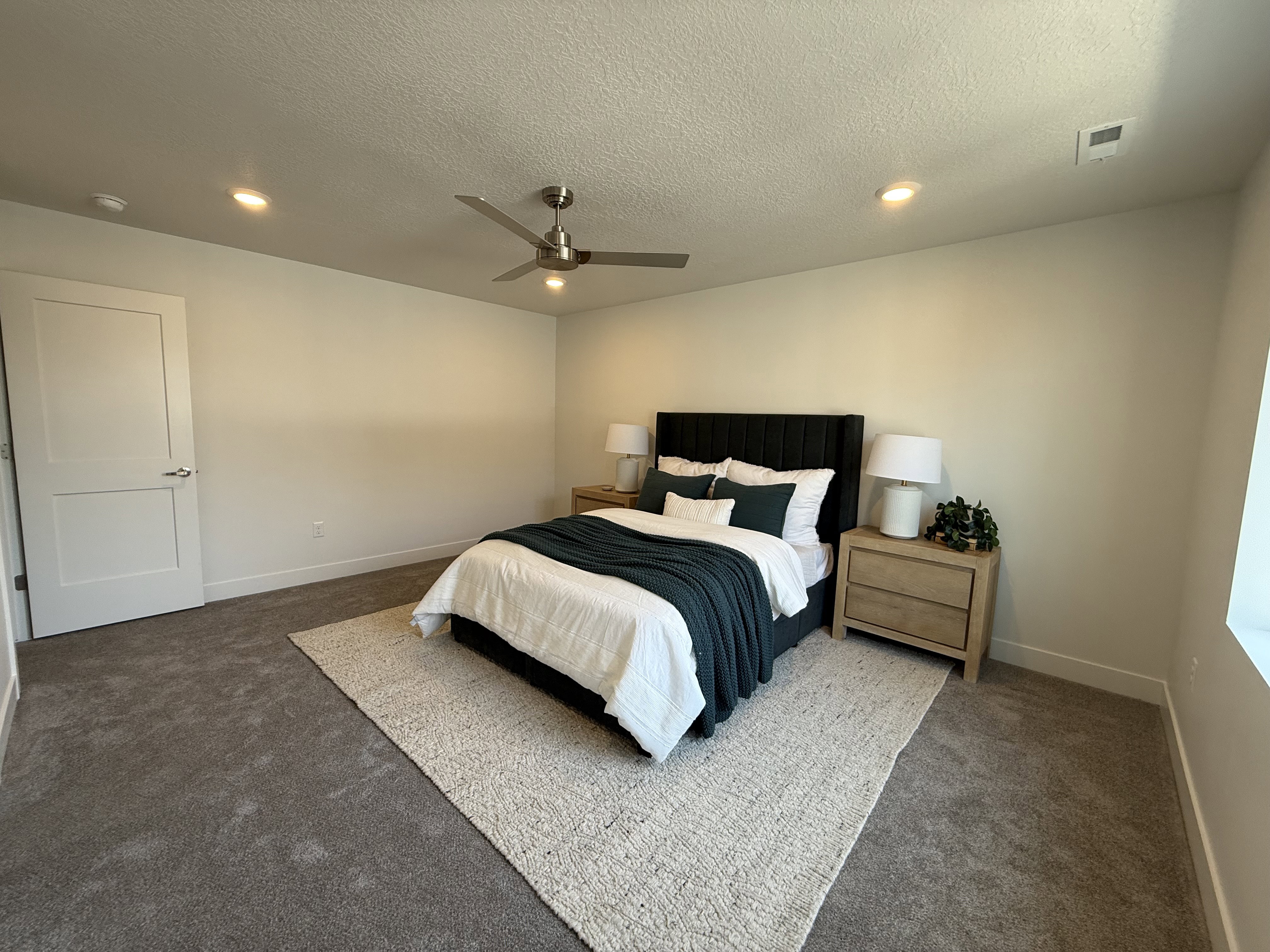 Spacious room featuring plush carpet flooring, recessed lighting, and a modern ceiling fan