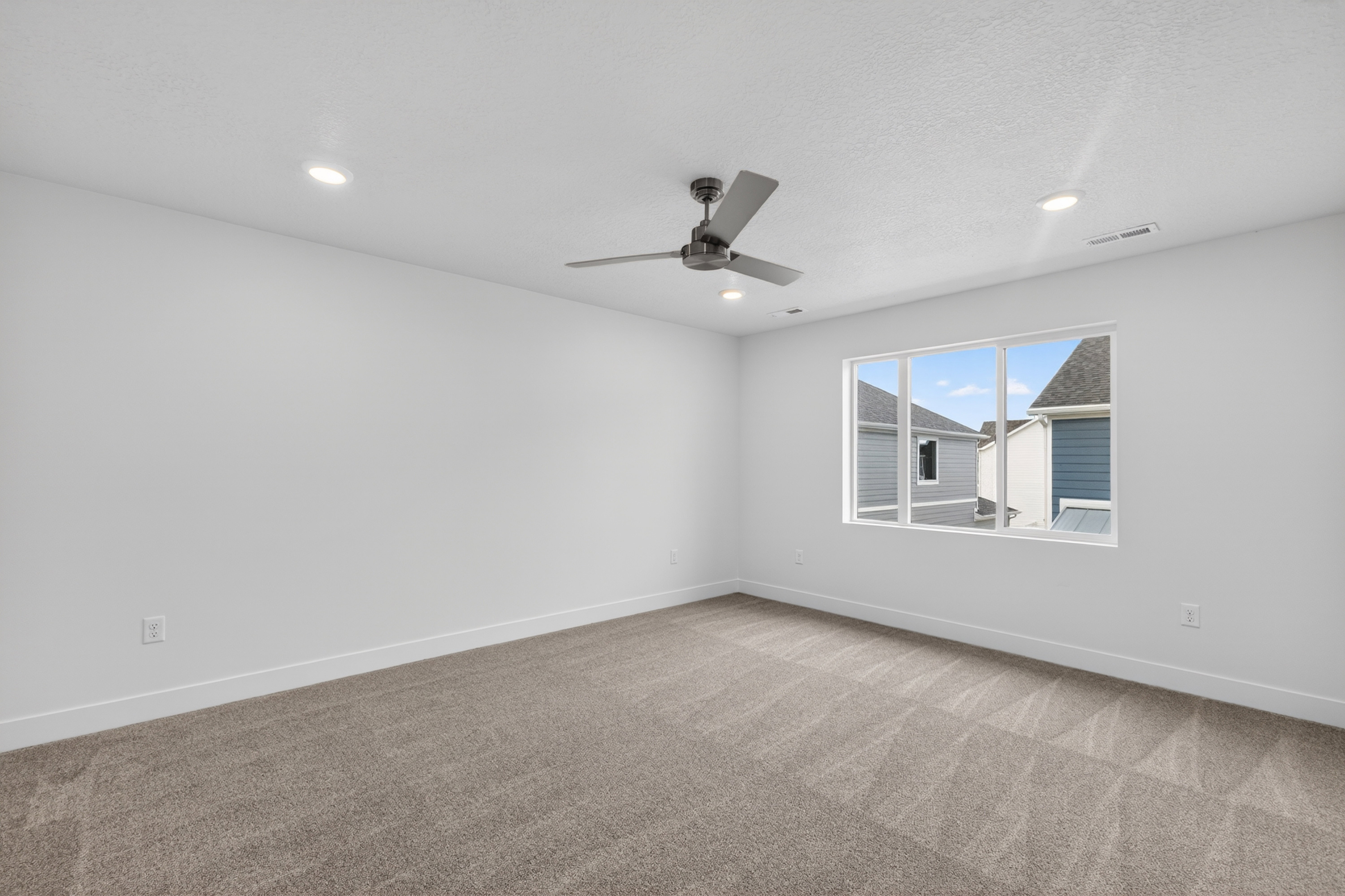 Spare room with carpet floors, a ceiling fan, recessed lighting, and a textured ceiling