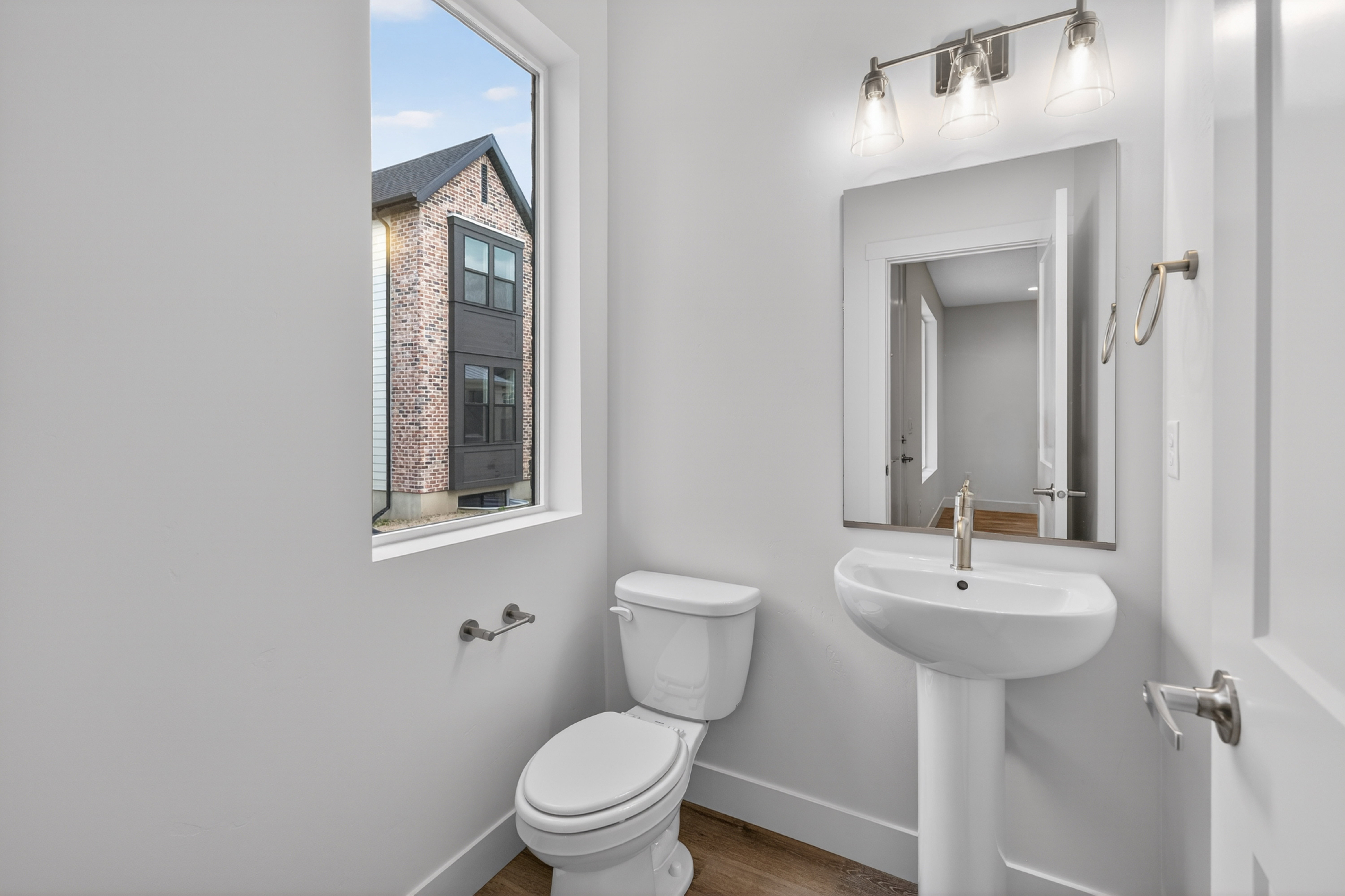 Bathroom with toilet and wood finished floors
