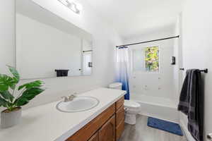 Full bathroom featuring vanity and shower / bath combination with curtain