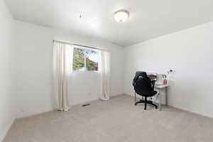 Office area with light carpet and baseboards