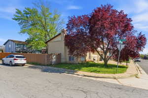 View of front of house with a chimney and brick siding