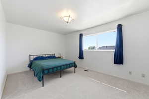 Bedroom featuring carpet and baseboards