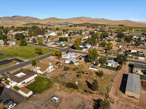 Aerial view of property's location featuring a mountain backdrop and nearby suburban area