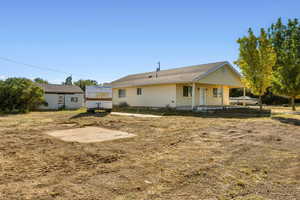 Rear view of property featuring covered porch
