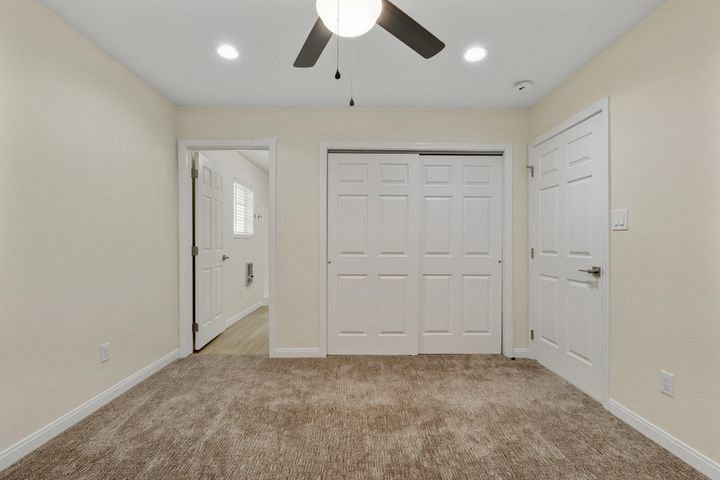 Unfurnished bedroom with light colored carpet, a closet, ceiling fan, and recessed lighting